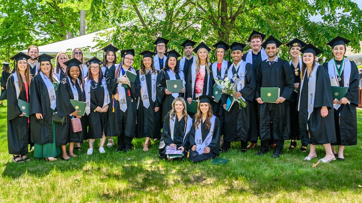 HVCC graduates gather together outside at commencement